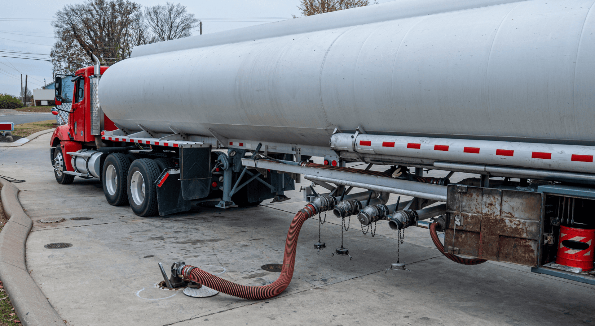 A commercial tanker truck undergoing a refueling operation