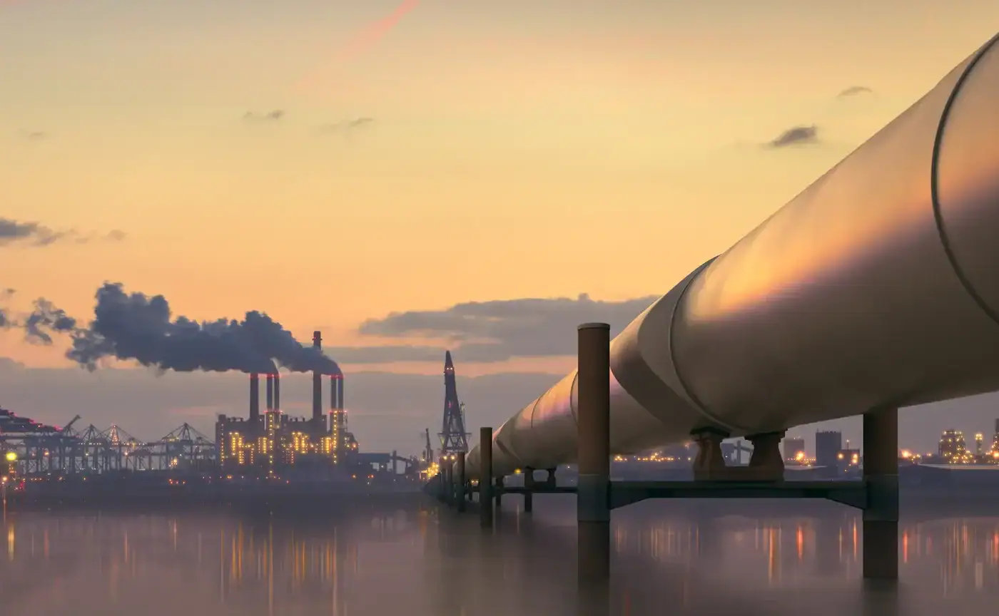 Pipelines against sunset industrial landscape