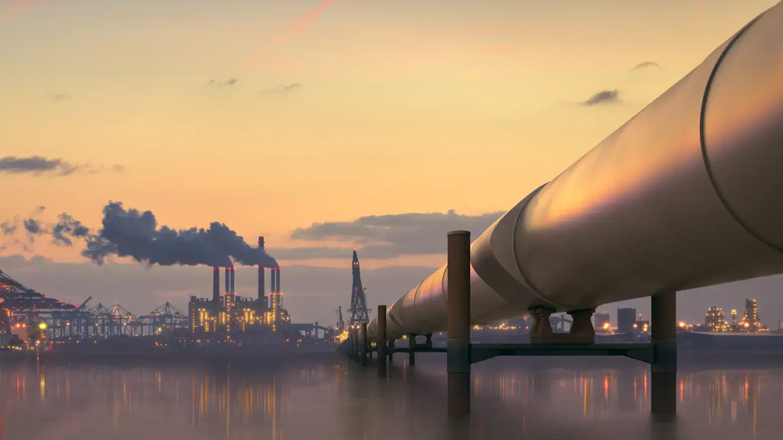 Pipelines against sunset industrial landscape
