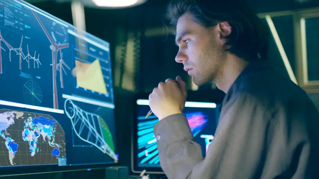 Man looking at maps on computer screen