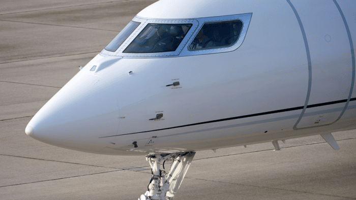 Business jet parked on the tarmac.