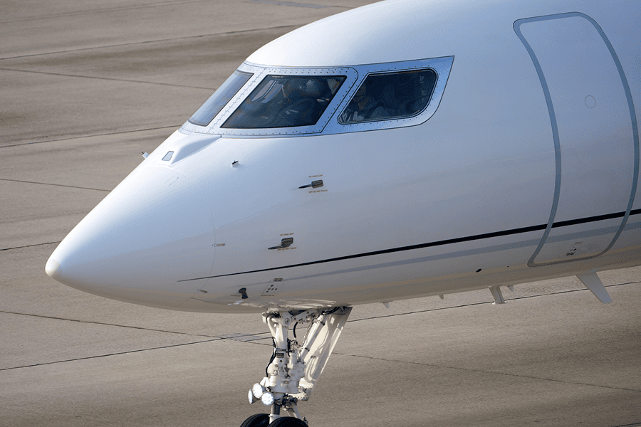 Business jet parked on the tarmac.
