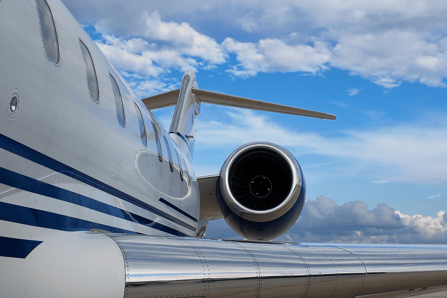 Close-up of business jet wing and engine