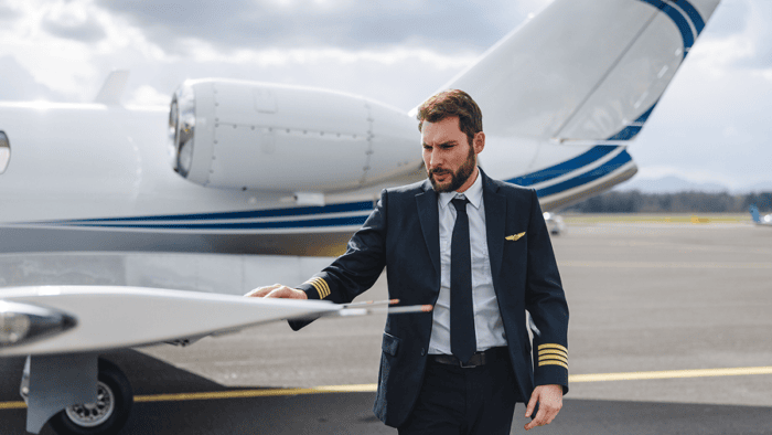 Pilot inspecting business jet on ramp
