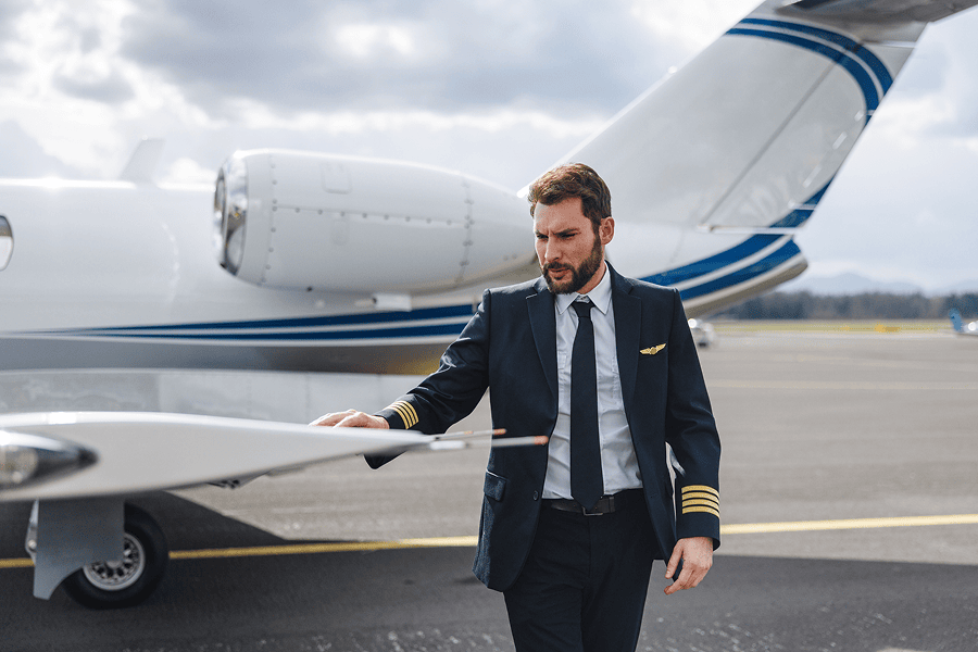 Pilot inspecting business jet on ramp