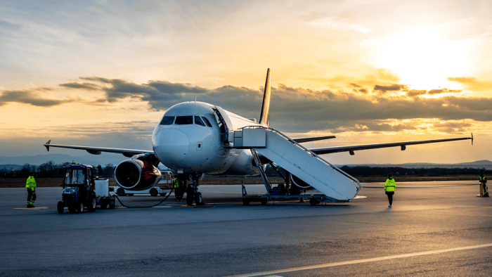 Commercial plane being serviced on ramp.