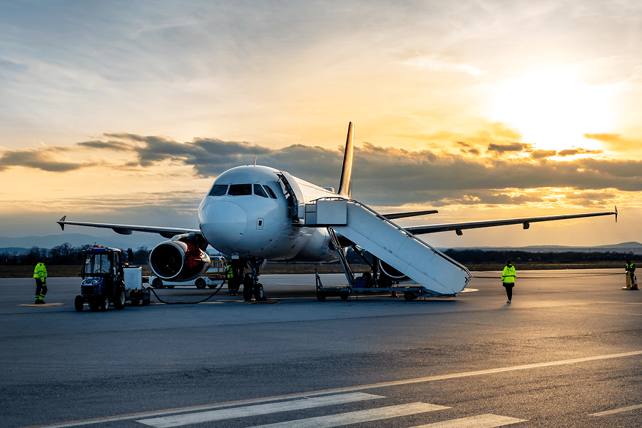 Commercial plane being serviced on ramp.