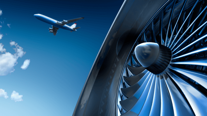 Aircraft flying near turbine close-up.
