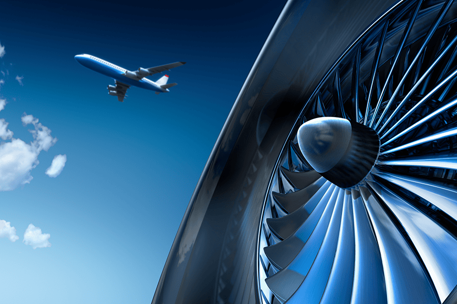 Aircraft flying near turbine close-up.