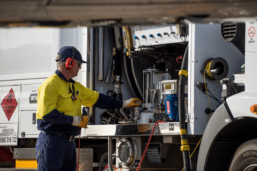 Man servicing truck fuel system.