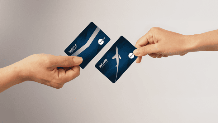 Two hands exchanging travel cards.