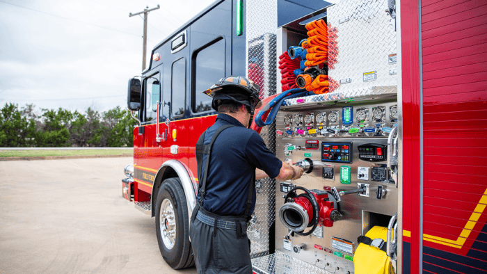 Fireman operating firetruck equipment.