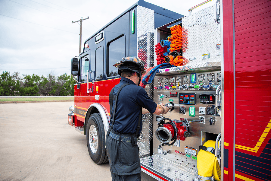 Fireman operating firetruck equipment.