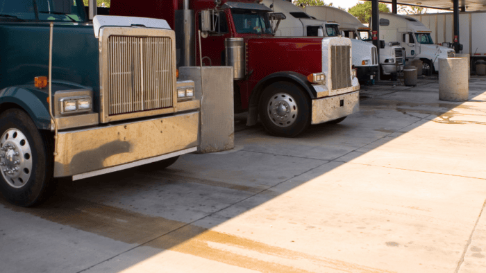 Trucks lined up at a fuel station.