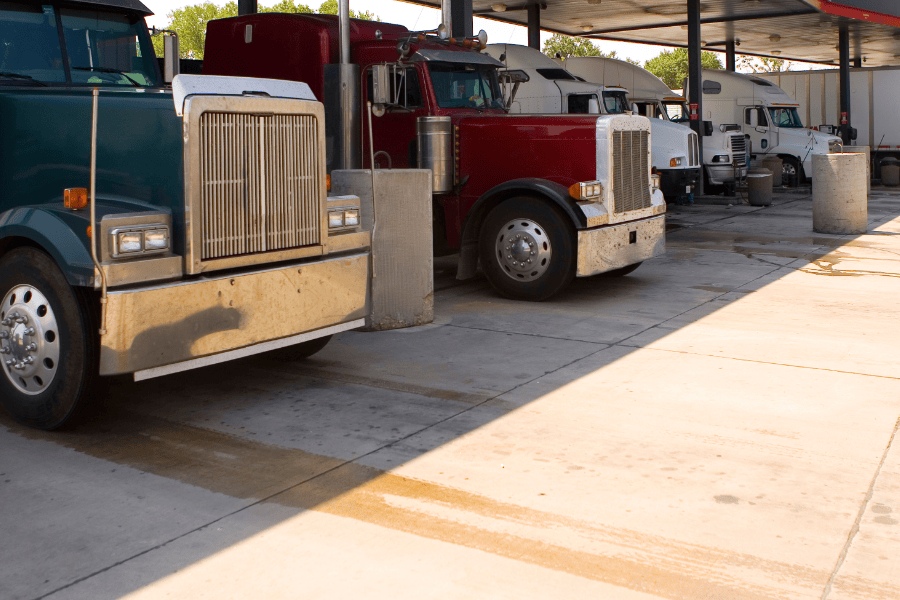 Trucks lined up at a fuel station.