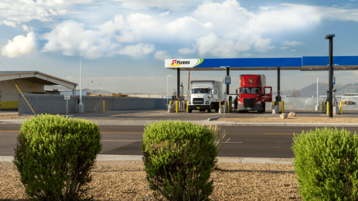 Two trucks refuelling at service station.