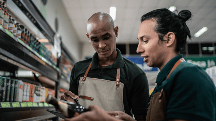 Two men discussing products in store.