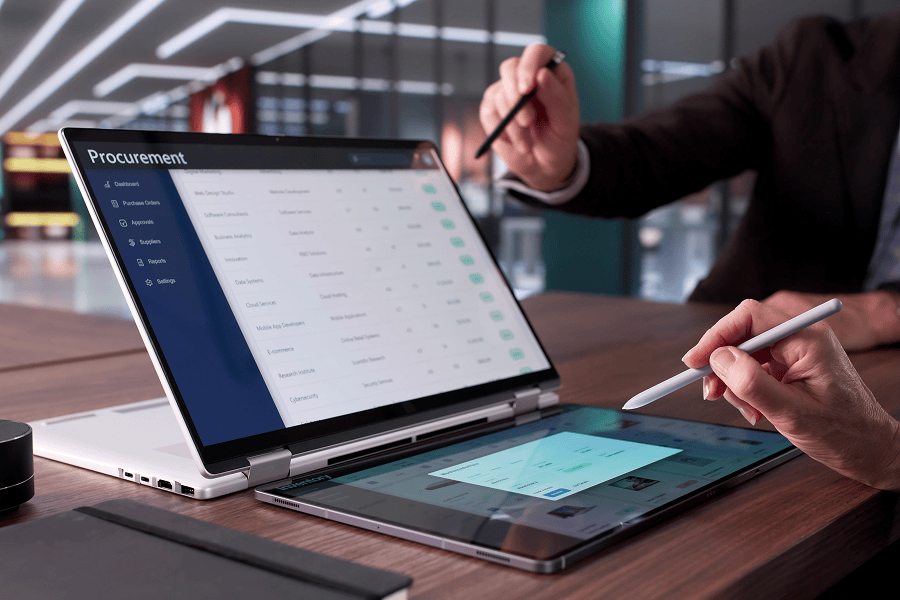 Two people using laptops and tablet.