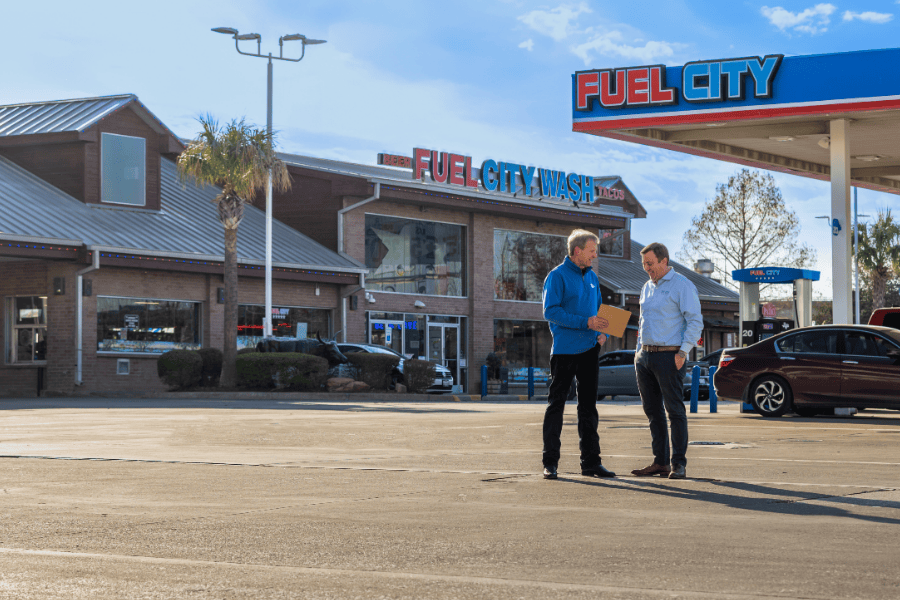 Two men talking outside Fuel City