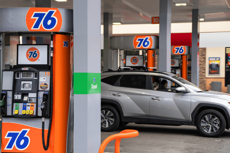 fuel pumps at gas station with car
