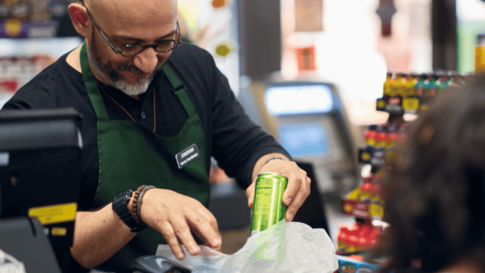 Man putting items in bag