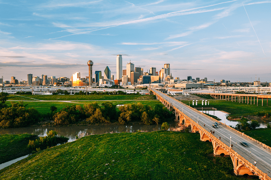 Dallas skyline with river and bridge.