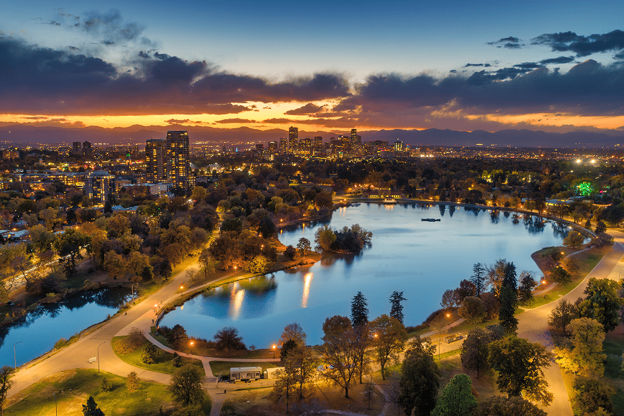 Denver's city skyline at sunset over lake