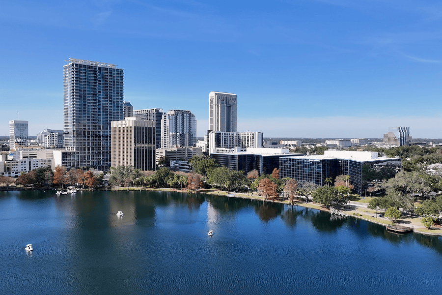 Orlando skyline reflecting on tranquil lake.
