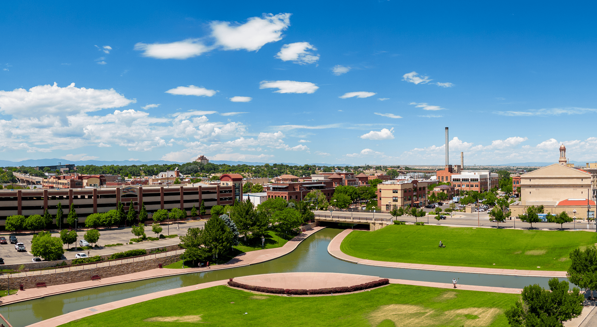 Sunny Pueblo, Colorado cityscape with green park.