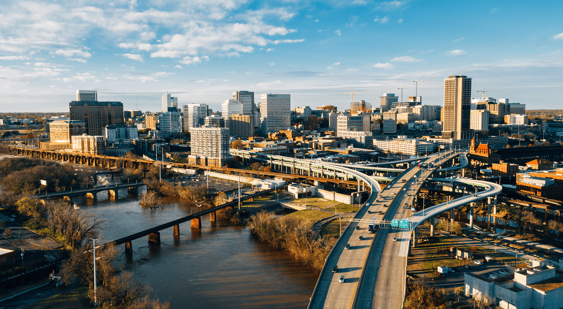 City skyline of Richmond, Virginia with river and highways.