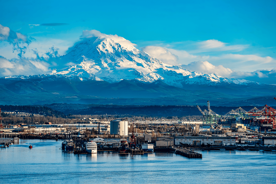 Mountains overlooking a bustling Tacoma harbour.