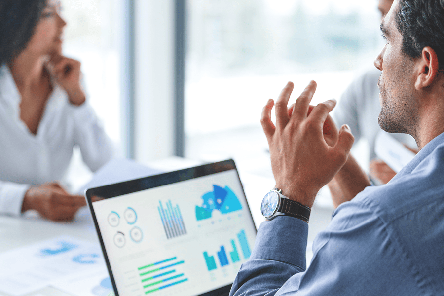 Businessman discussing statistics in meeting.