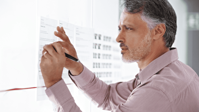 A businessman in a modern office planning his next move for corporate strategy