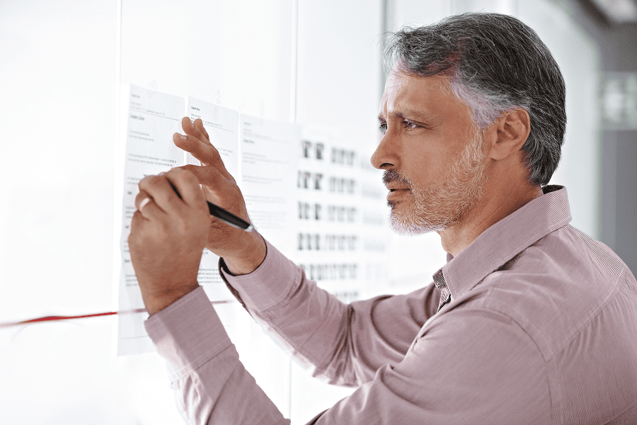 A businessman in a modern office planning his next move for corporate strategy