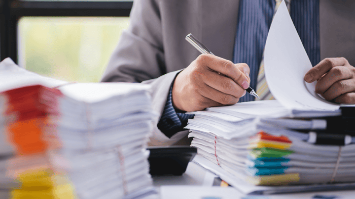 A business professional's hands reviewing papers