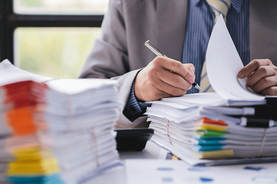 A business professional's hands reviewing papers