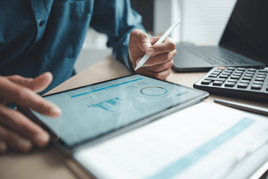 A corporate procurement professional collaborating over data and financial reports inside a modern office