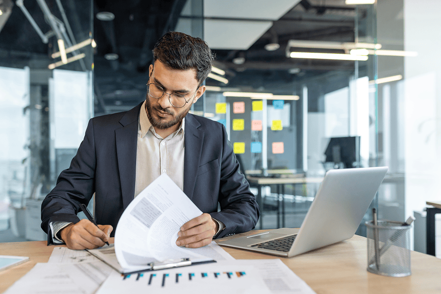 man writing on document