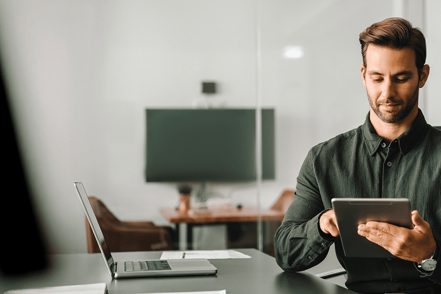 man looking down at tablet