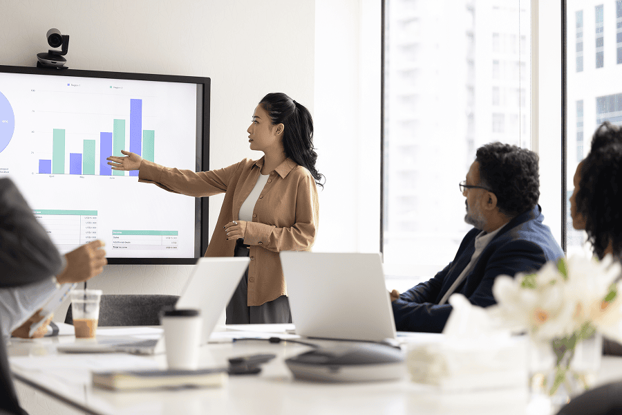 woman presenting graphs to people