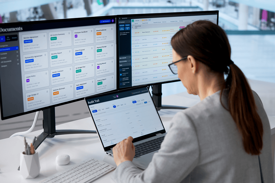 Person working on dual computer screens.
