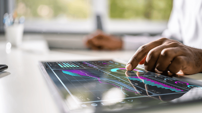 Businessman analysing data on tablet