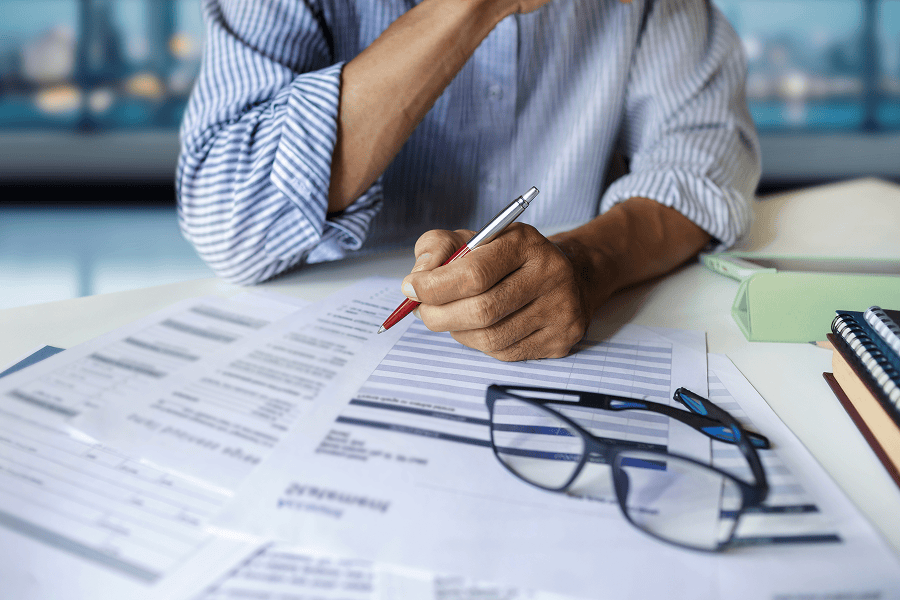 Businessman reviewing documents at desk.