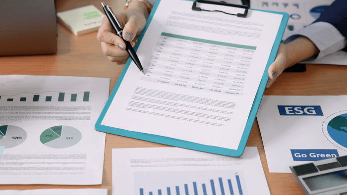 Reports and charts on a desk.