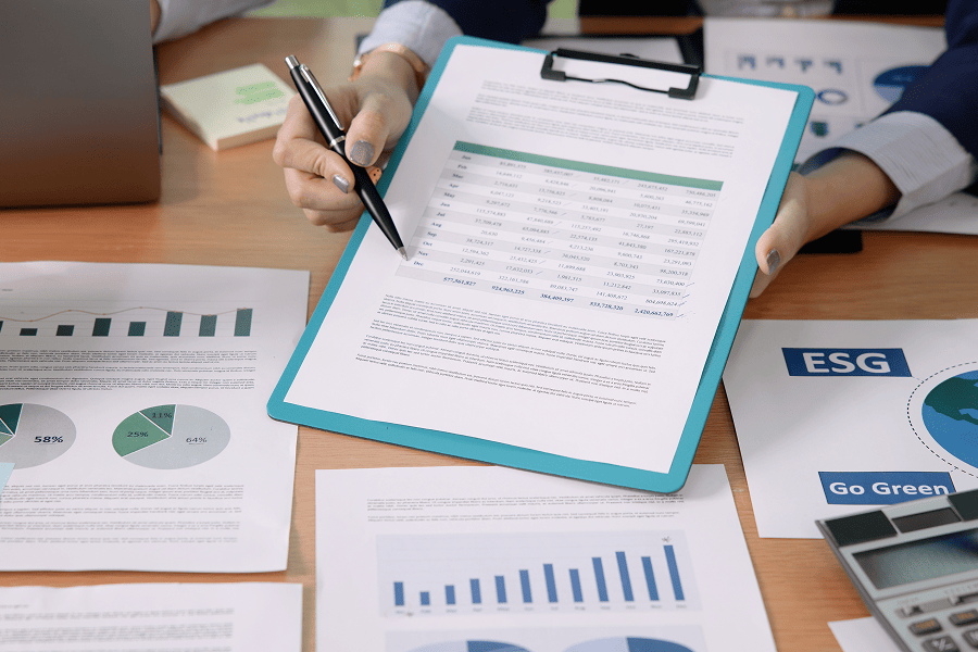 Reports and charts on a desk.
