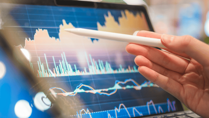 A financial analyst reviewing metrics on a laptop screen