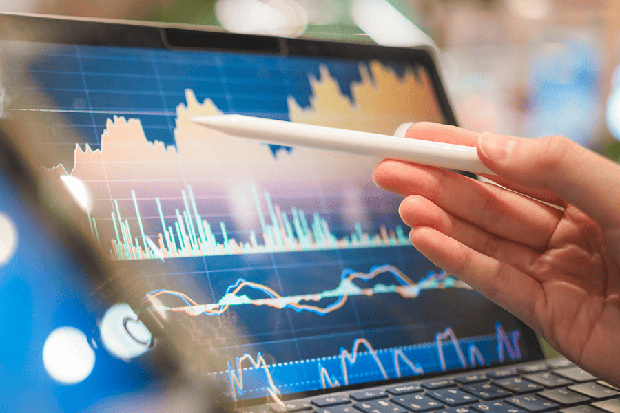 A financial analyst reviewing metrics on a laptop screen
