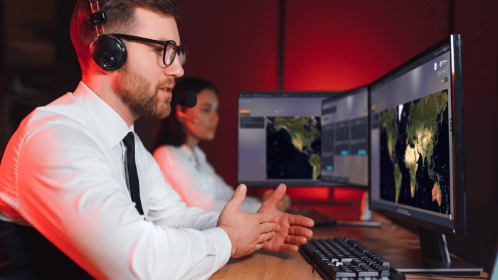 Two professionals working at computers.