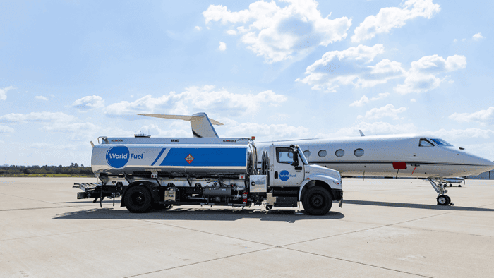 Fuel truck next to private jet.