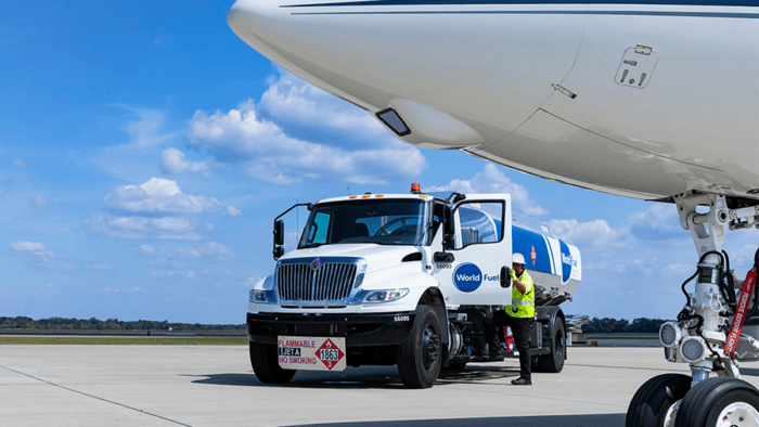 Fuel truck servicing an aircraft on tarmac